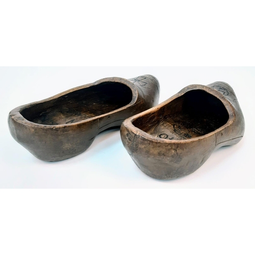 782 - Pair of Dutch clogs that have been crudely engraved by a German soldier to mark the successful invas... 