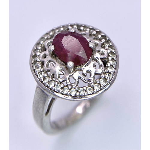 1383 - A VERY ATTRACTIVE SILVER RING WITH CENRAL RUBY STONE .     4.6gms   size O