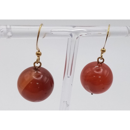 1397 - A PAIR OF RED JADE BALL EARRINGS IN YELLOW METAL .