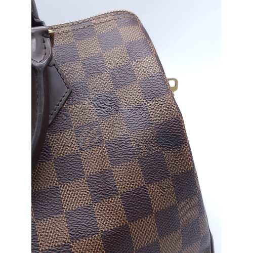 366 - A Louis Vuitton Speedy Damier Ebene Handbag. A leather exterior, with two rolled handles, gold toned... 