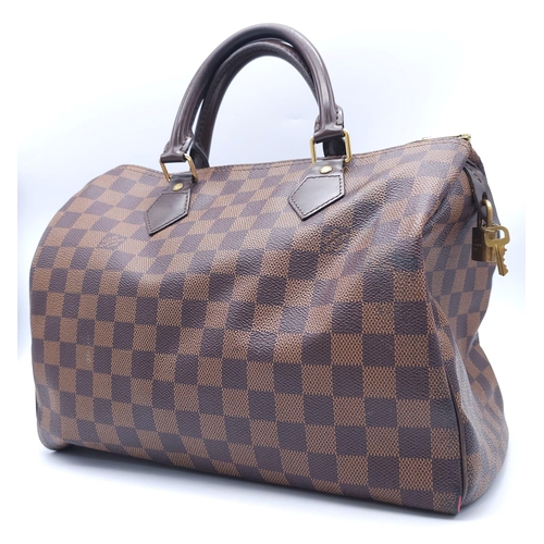 366 - A Louis Vuitton Speedy Damier Ebene Handbag. A leather exterior, with two rolled handles, gold toned... 