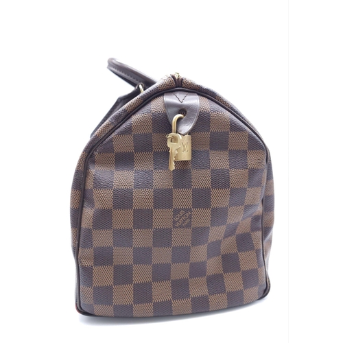 366 - A Louis Vuitton Speedy Damier Ebene Handbag. A leather exterior, with two rolled handles, gold toned... 