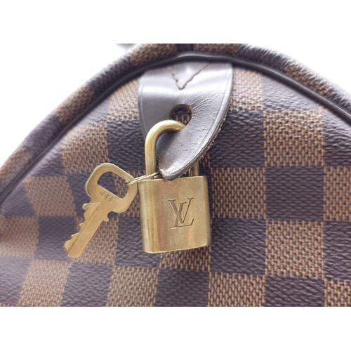 366 - A Louis Vuitton Speedy Damier Ebene Handbag. A leather exterior, with two rolled handles, gold toned... 