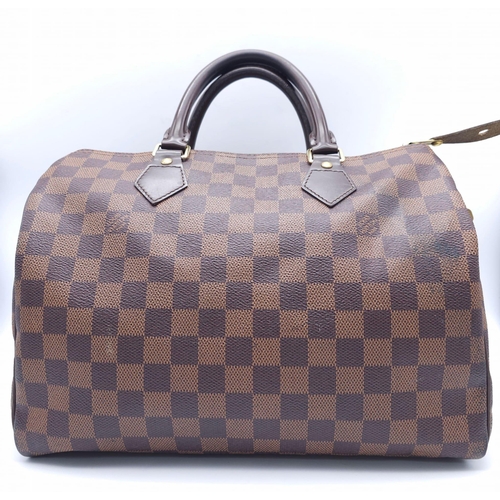 366 - A Louis Vuitton Speedy Damier Ebene Handbag. A leather exterior, with two rolled handles, gold toned... 