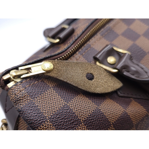 366 - A Louis Vuitton Speedy Damier Ebene Handbag. A leather exterior, with two rolled handles, gold toned... 