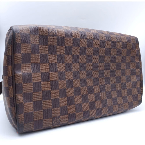 366 - A Louis Vuitton Speedy Damier Ebene Handbag. A leather exterior, with two rolled handles, gold toned... 