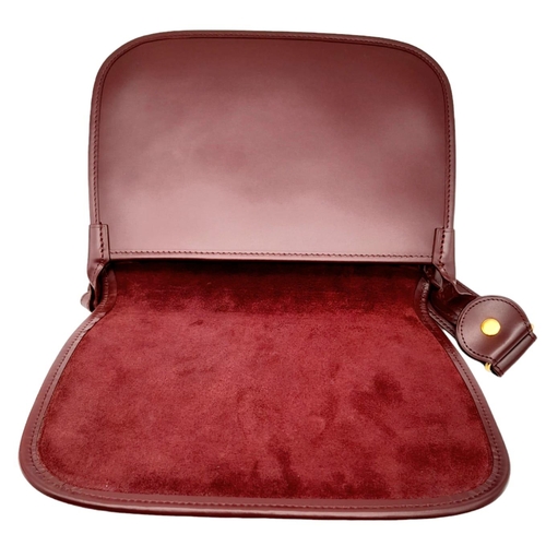 402 - Cartier Burgundy Shoulder Bag.
Quality soft leather exterior with rich suede accents, embossed C mot... 