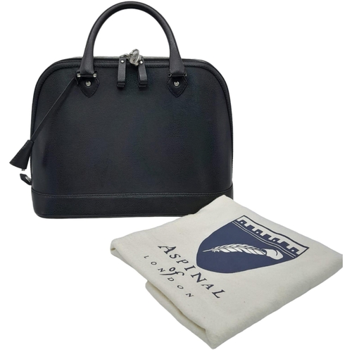 454 - An Aspinal Black Hepburn Bag. Lizard print leather exterior with rolled leather handles, silver tone... 