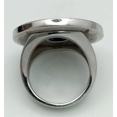 178 - A Bulgari White Gold and Onyx Ring. A stand-out piece in circular branded white gold and black onyx.... 