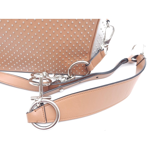 416 - A Tod's Mini Gommino Bag. Studded leather exterior with two handles, silver toned hardware, top zip ... 