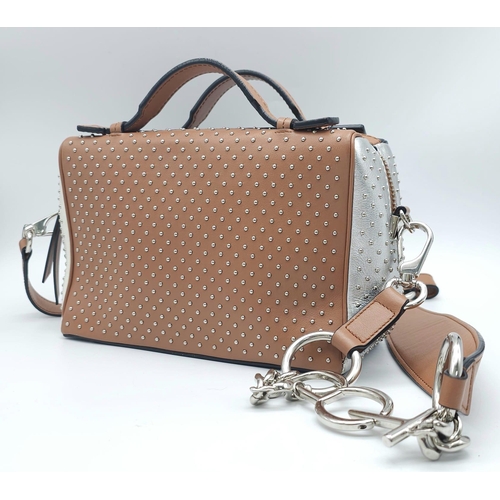 416 - A Tod's Mini Gommino Bag. Studded leather exterior with two handles, silver toned hardware, top zip ... 