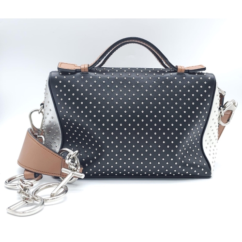 416 - A Tod's Mini Gommino Bag. Studded leather exterior with two handles, silver toned hardware, top zip ... 