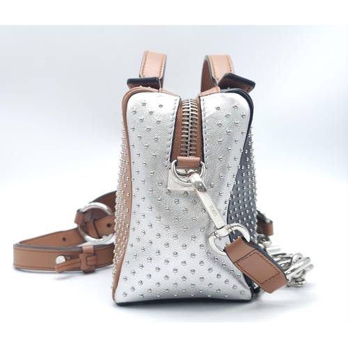 416 - A Tod's Mini Gommino Bag. Studded leather exterior with two handles, silver toned hardware, top zip ... 