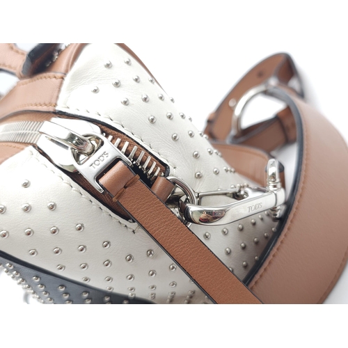 416 - A Tod's Mini Gommino Bag. Studded leather exterior with two handles, silver toned hardware, top zip ... 