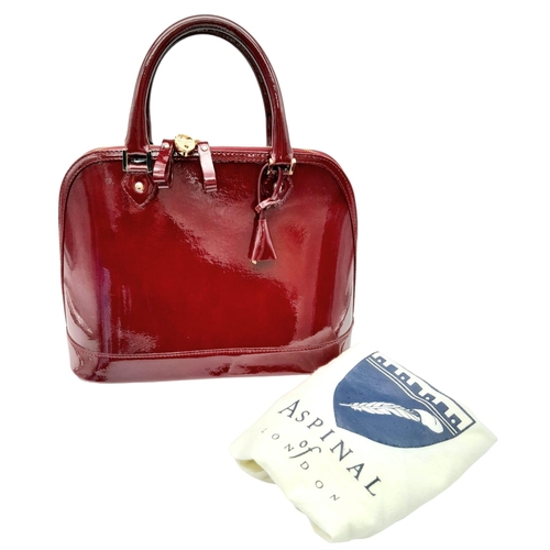 528 - An Aspinal Bright Burgundy Hepburn Bag. Patent leather exterior with rolled patent leather handles, ... 