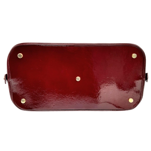 528 - An Aspinal Bright Burgundy Hepburn Bag. Patent leather exterior with rolled patent leather handles, ... 