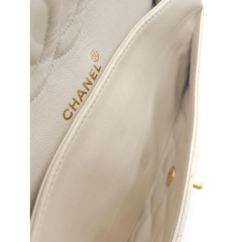 59 - Chanel Cream Maxi.
Double handled, quilted in diamond stitching and quality leather throughout. Gold... 