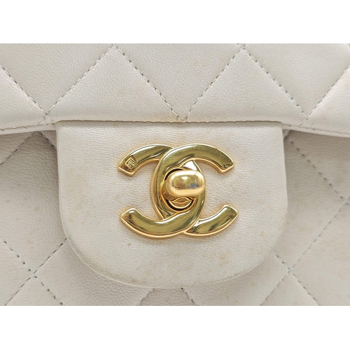 59 - Chanel Cream Maxi.
Double handled, quilted in diamond stitching and quality leather throughout. Gold... 