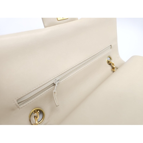 59 - Chanel Cream Maxi.
Double handled, quilted in diamond stitching and quality leather throughout. Gold... 