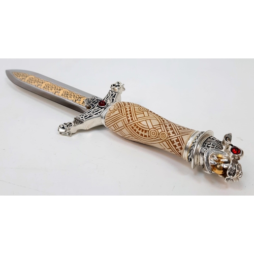 599 - An Excellent Condition, Gilt Decorated Gem Set, Celtic Design Dagger.
38cm Length. Comes In Wood and... 