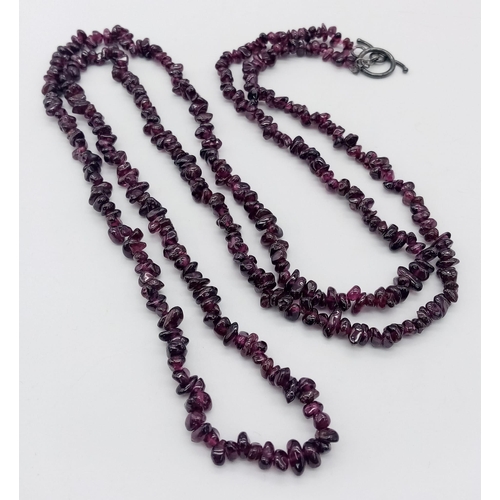 634 - An Ex Display, Sterling Silver T-Bar Garnet Necklace. 
100cm Length, can be worn single or doubled. ... 