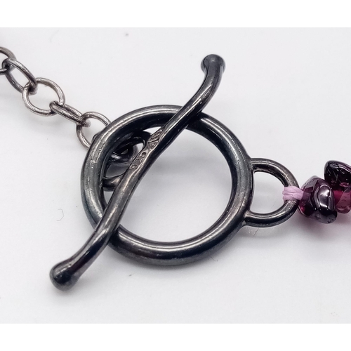 634 - An Ex Display, Sterling Silver T-Bar Garnet Necklace. 
100cm Length, can be worn single or doubled. ... 