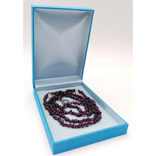 634 - An Ex Display, Sterling Silver T-Bar Garnet Necklace. 
100cm Length, can be worn single or doubled. ... 