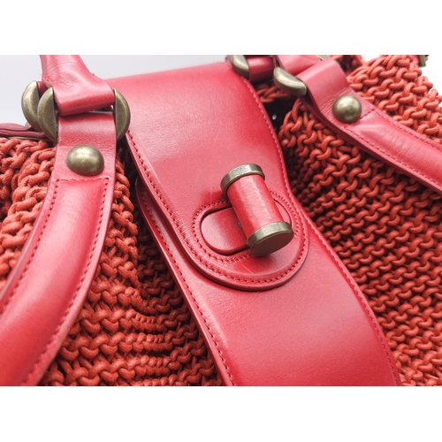 79 - Alexander McQueen Red Woven Coated Canvas and Leather Novak Satchel.
Versatile and functional, well-... 