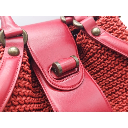 79 - Alexander McQueen Red Woven Coated Canvas and Leather Novak Satchel.
Versatile and functional, well-... 