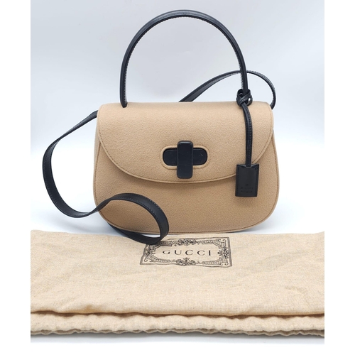 218 - Gucci Tan Wool Purse.
This Gucci tan wool purse features a black bar closure, black leather handle, ... 