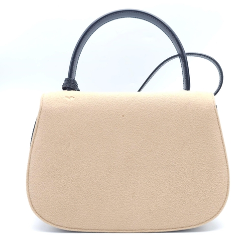 218 - Gucci Tan Wool Purse.
This Gucci tan wool purse features a black bar closure, black leather handle, ... 