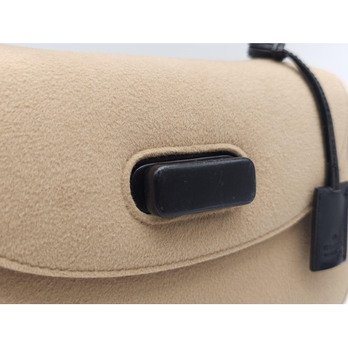 218 - Gucci Tan Wool Purse.
This Gucci tan wool purse features a black bar closure, black leather handle, ... 