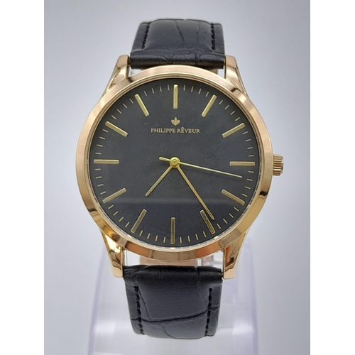 1022 - An Unworn Cased Men’s Gold Tone Quartz Watch by Philippe Reveur.
42mm including crown comes with Mat... 