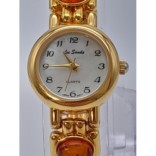 1209 - An Unworn Ladies Gold Tone Amber Set Quartz Watch by the Jeweller Lee Sands. 
19cm Length including ... 