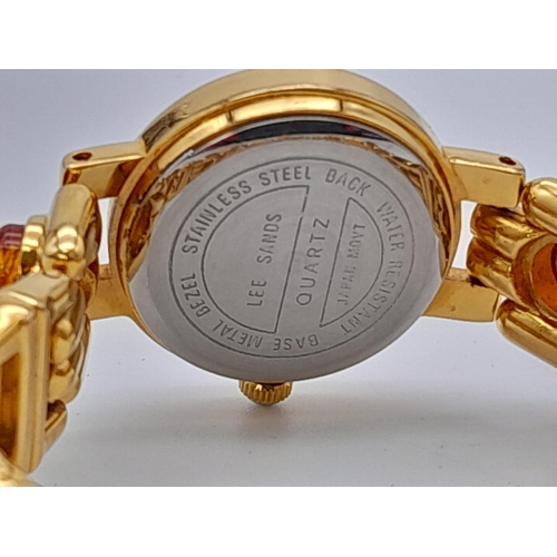 1209 - An Unworn Ladies Gold Tone Amber Set Quartz Watch by the Jeweller Lee Sands. 
19cm Length including ... 