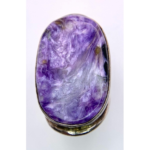 1225 - A Sterling Silver Oval Purple Stone Set Ring. Size P, 20.7g total weight.