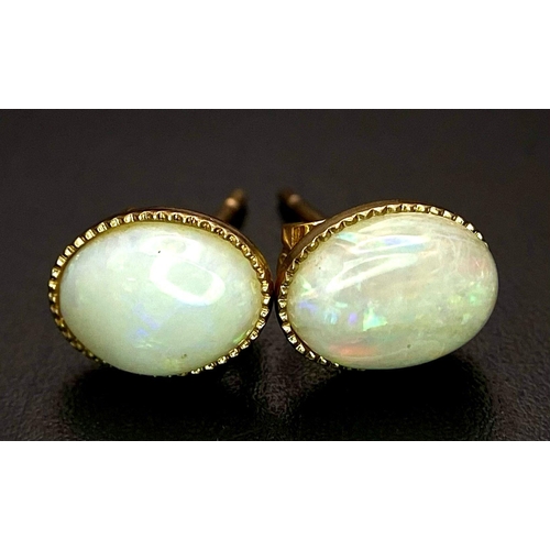 1376 - A PAIR OF OPEL CABOCHON EARRINGS IN 9K GOLD.  1.2gms