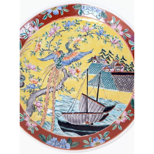 1785 - A pair of large, wonderful Chinese Famille Jaune enamelled Plates. Depicting boats, houses and phoen... 