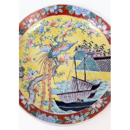 1785 - A pair of large, wonderful Chinese Famille Jaune enamelled Plates. Depicting boats, houses and phoen... 