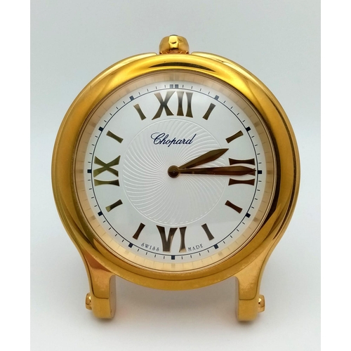 274 - A Chopard Happy Sport Gold Plated Table Clock. Quartz movement. 7.5cm diameter. White dial with Roma... 