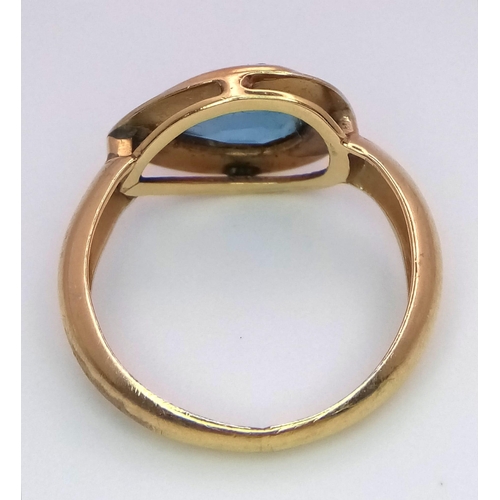 288 - An 18K Yellow Gold Blue Gemstone (possibly topaz) Ring. Pear shaped stone set within a raised founda... 