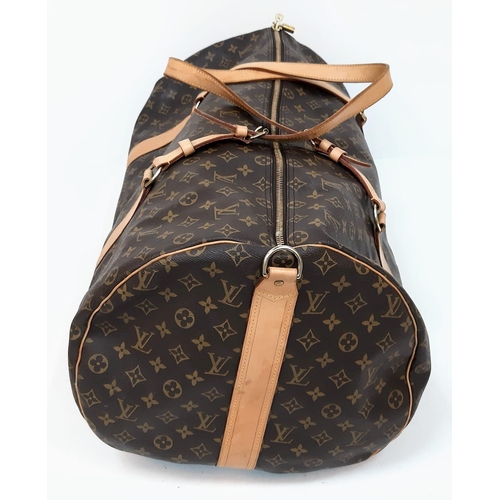 359 - Large Luis Vuitton Duffle Bag. 
Famed LV monogrammed canvass, double carry handles and attached shou... 