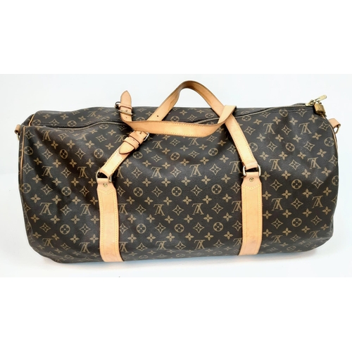 359 - Large Luis Vuitton Duffle Bag. 
Famed LV monogrammed canvass, double carry handles and attached shou... 