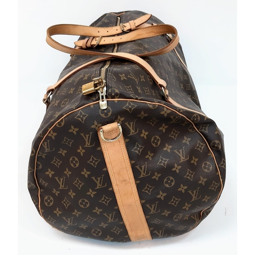 359 - Large Luis Vuitton Duffle Bag. 
Famed LV monogrammed canvass, double carry handles and attached shou... 