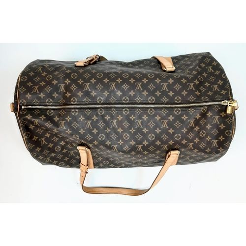 359 - Large Luis Vuitton Duffle Bag. 
Famed LV monogrammed canvass, double carry handles and attached shou... 