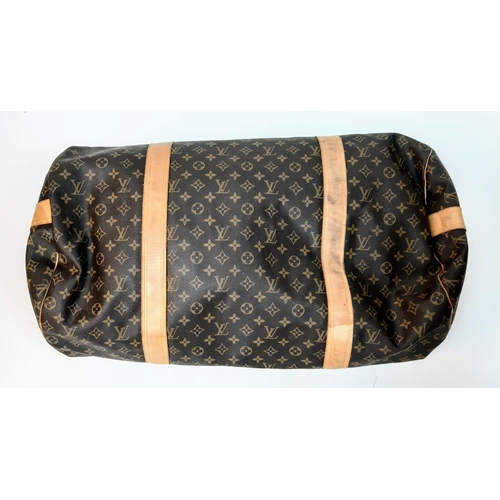 359 - Large Luis Vuitton Duffle Bag. 
Famed LV monogrammed canvass, double carry handles and attached shou... 