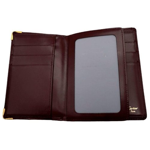 423 - Cartier Burgundy Leather Wallet.
Stylish gold toned hardware and famed CC embossed logo front. Sever... 