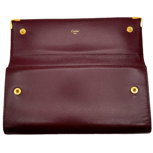 461 - Cartier Burgundy Leather Purse.
'CC' embossed logo on front with gold toned hardware. Back compartme... 