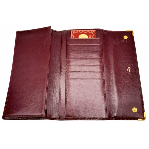 461 - Cartier Burgundy Leather Purse.
'CC' embossed logo on front with gold toned hardware. Back compartme... 