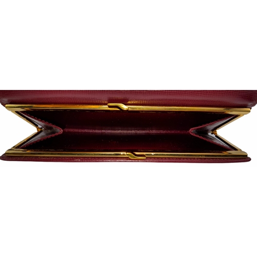 461 - Cartier Burgundy Leather Purse.
'CC' embossed logo on front with gold toned hardware. Back compartme... 